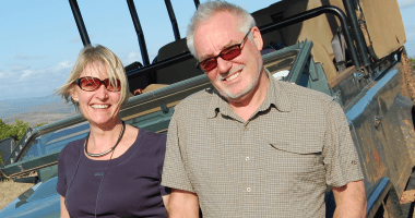 Cathy and Jim Miles looking into the camera and smiling