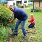 Man holding a shovel in a garden