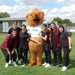 Teenagers with furry bear mascot
