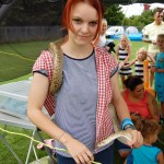 Teenage girl with snake round shoulders