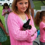 Young girl holding small bunny rabbit