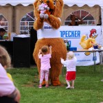 Bear mascot holding teddy