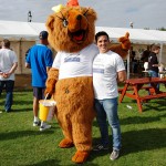 Man standing with bear mascot