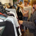 Shoppers browsing clothes rail