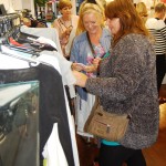 Shoppers browsing clothes rail