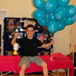 Teen boy holding bunch of balloons
