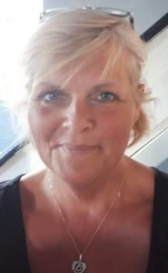 Mandy has short blonde hair and smiles brightly into the camera.