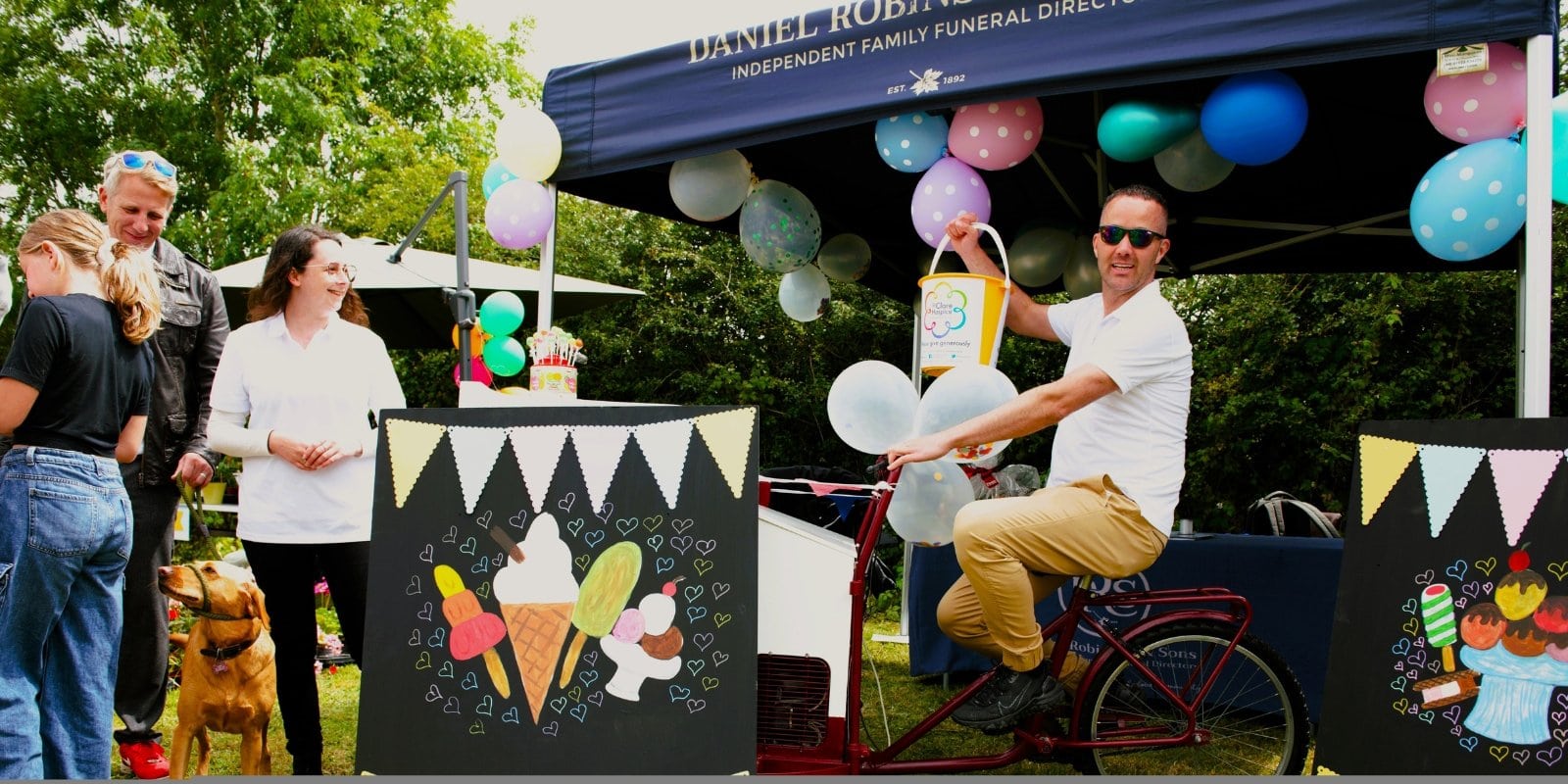Photo of attendees and a stallholder at the 2024 St Clare Summer Fayre.