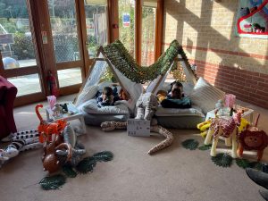Photo of Ollie and Max in the teepees at St Clare Hospice. They are pictured looking through binoculars.