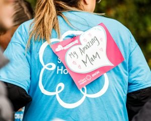 A St Clare t-shirt is pictured with a sign that reads: "Walking in Memory of my amazing mam."