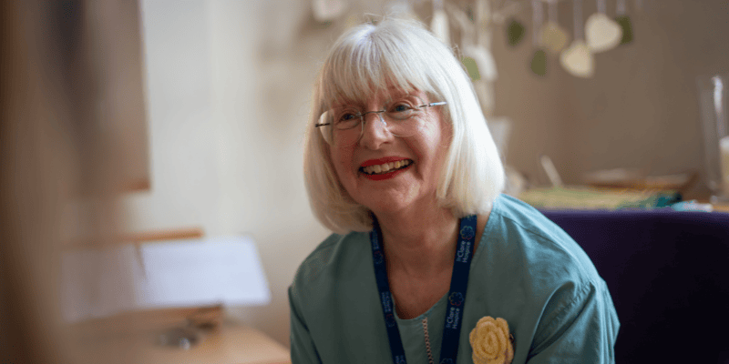 Photo of Joy - a Hospice pastoral support volunteer - speaking to someone.
